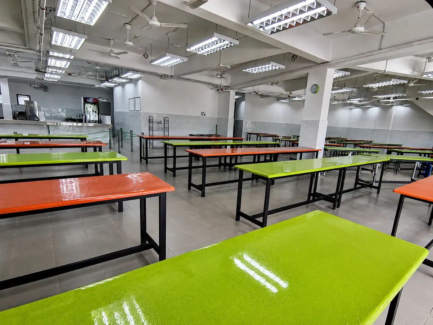 School canteen with rows of tables and benches