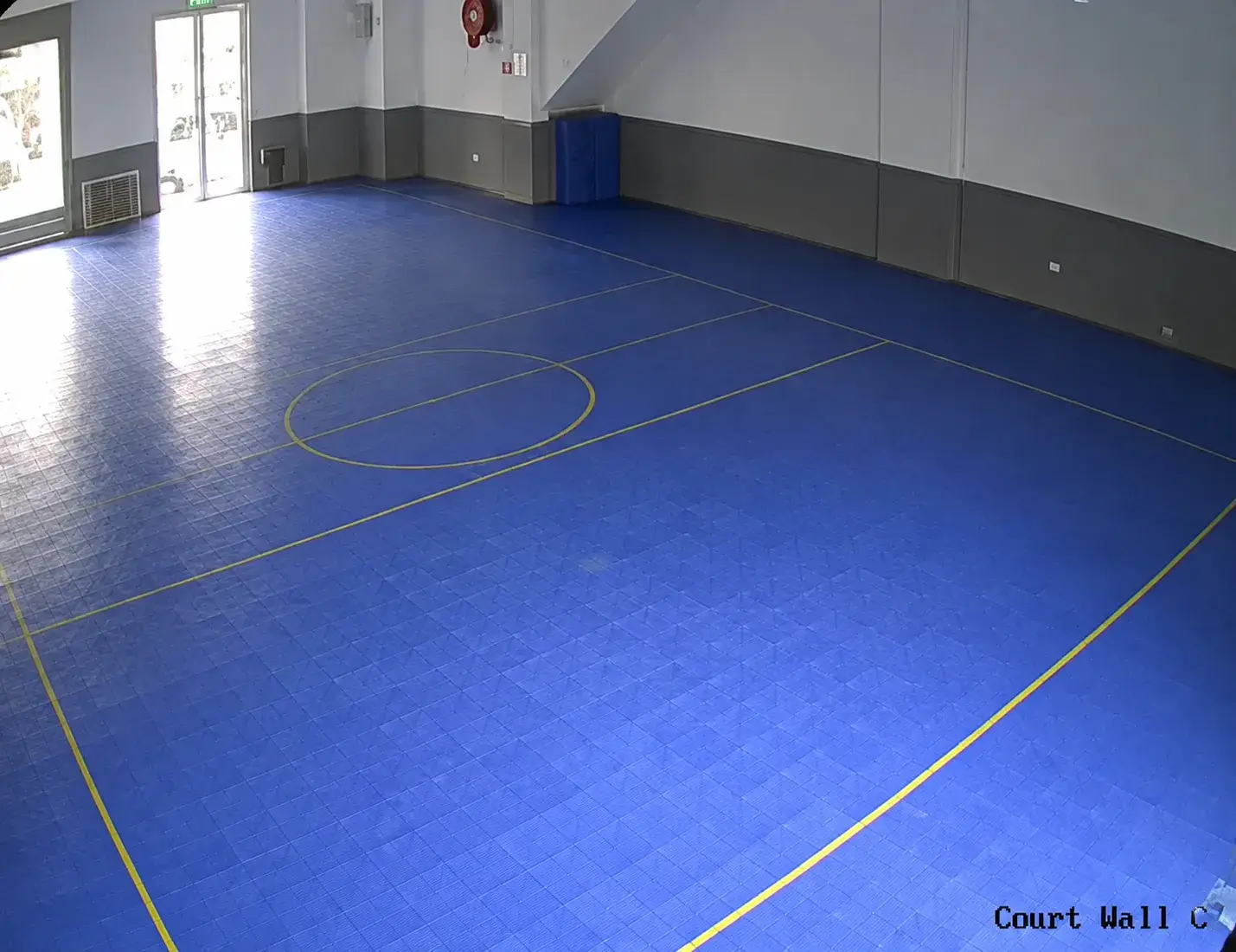 Indoor games hall with a blue court floor