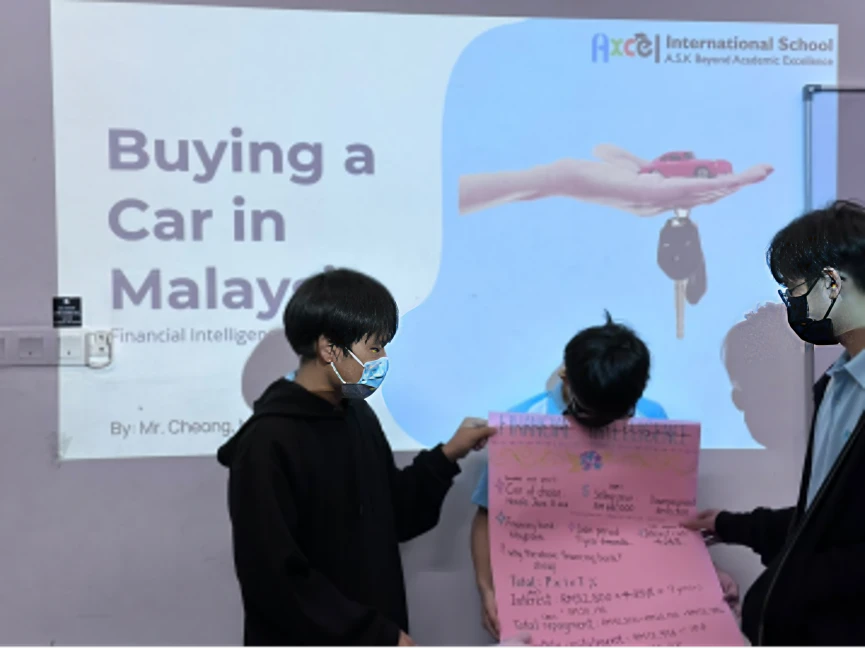 Secondary students presenting "Buying a Car in Malaysia" in a Financial Intelligence lesson