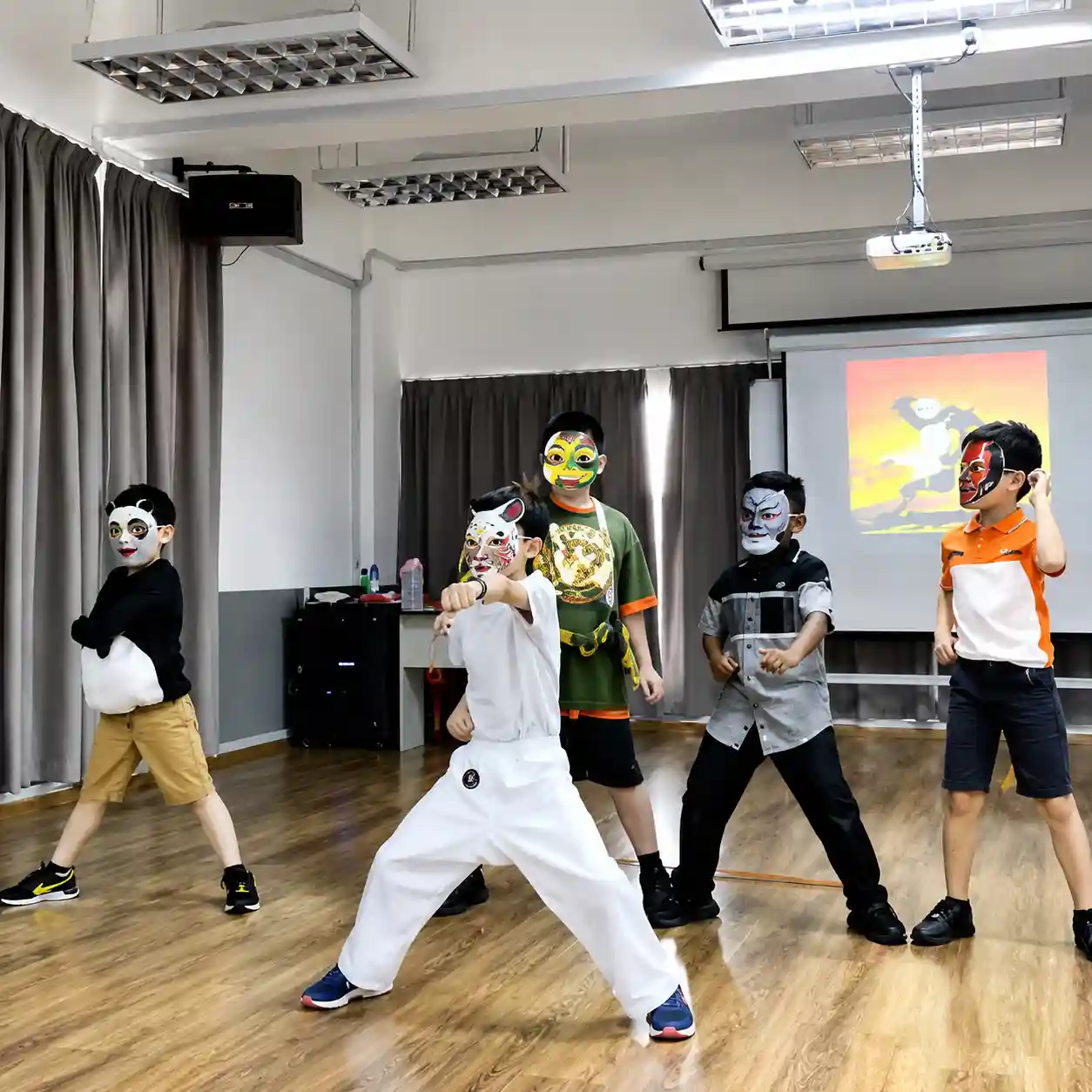 Students performing a masked drama piece