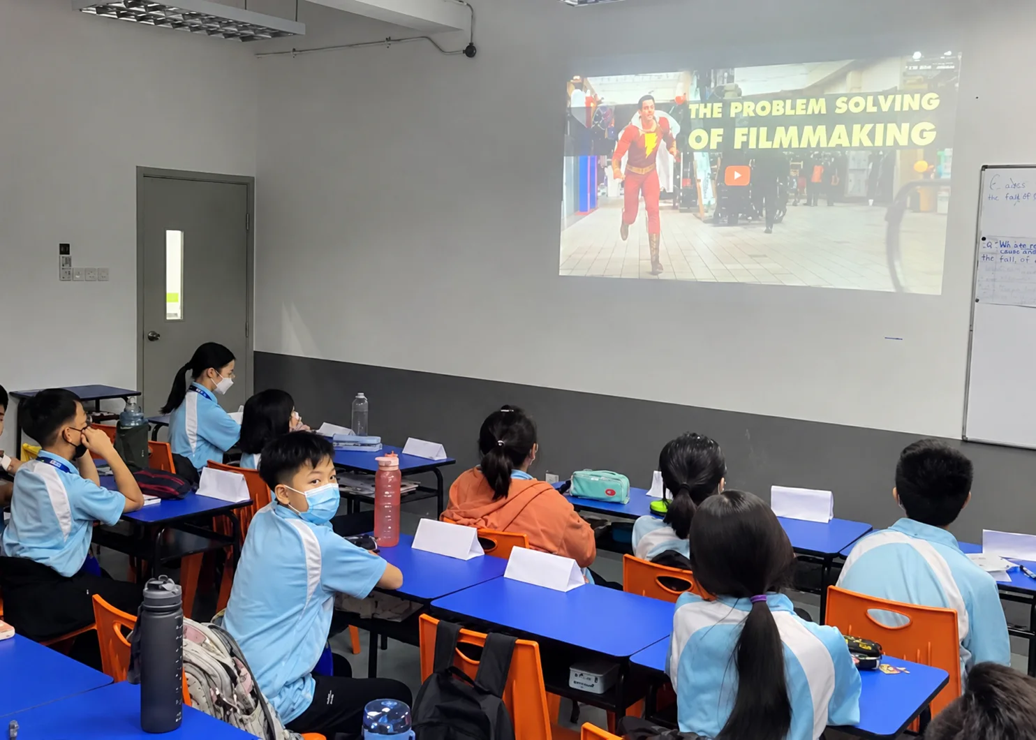 Secondary students in a classroom watching a presentation