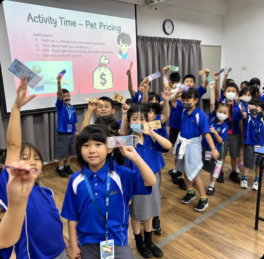 Primary students holding up play money during a Financial Intelligence activity