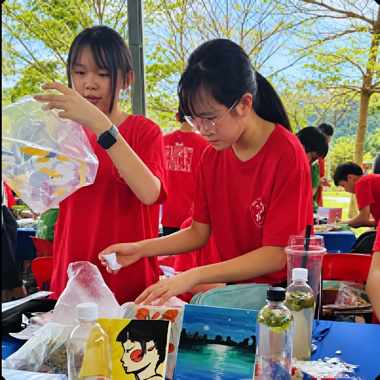 Students preparing food at an outdoor stall